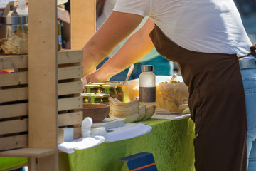 Serving customers at outdoor market with healthy local products.