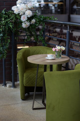 A cup of hot latte art coffee on wooden table background