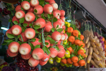 Colorful fake fruit hanging for sale  at popular market in Ayer Hitam