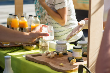 Serving customers at outdoor market with healthy local products.