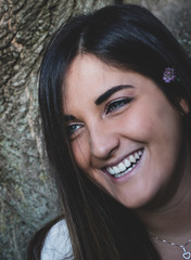 smiling girl with blue eyes and a flower - sunset at the park