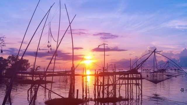 Timelapse 4K of beautiful sunrise with fishing trap in pak pra village, Phatthalung Thailand