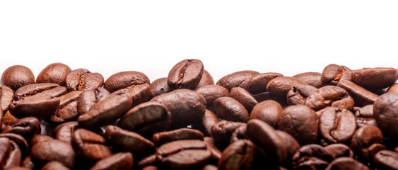 Coffee beans close-up, isolated on white background. Beautiful brown color roasted coffee beans.