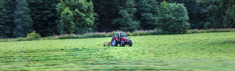a tracor on a meadow speed blur panorama