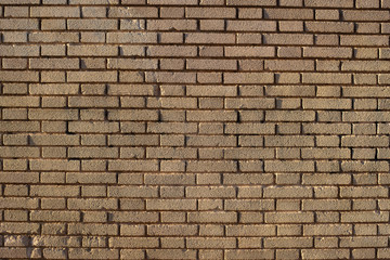 Brick wall background at sunset with sun rays, stone texture.