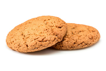 Homemade bakery. Two sweet cookies made from oatmeal flour. Tasty biscuit close-up isolated on white background. Homemade cookies.