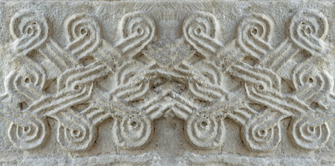Christian pattern carved in stone on the wall of an old Christian church in Georgia