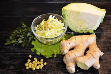 Vegetarian food. Salad of savoy catasta, green peas, ginger and olive oil.