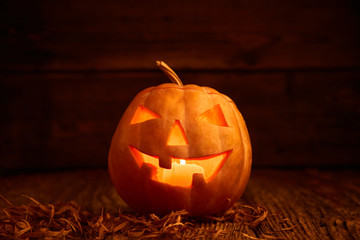 Halloween - old jack-o-lantern on wooden background