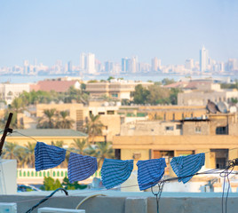 view from balcony - underwear hanging to dry on terrace with city skyline and sea background
