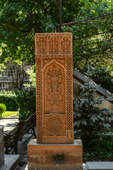 Fototapeta na wymiar Stone carved cross - khachkar in the Park on the territory of the Church 