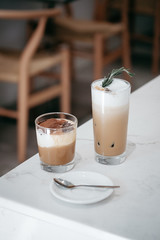 Glass of coffee on wooden table