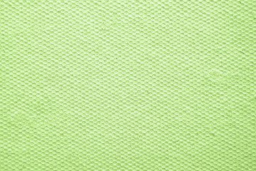 Abstract background of green color. Smooth pressed cardboard surface with recesses or honeycombs