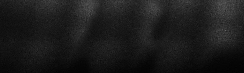 Panorama black paper texture or background with spotlight, dark wall backdrop wallpaper, dark tone.