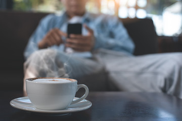 Man using mobile phone and coffee