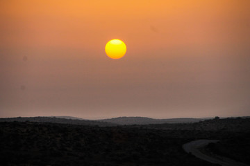 desert sunset with a cheese moon