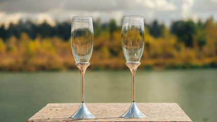 two glasses of white wine on a table