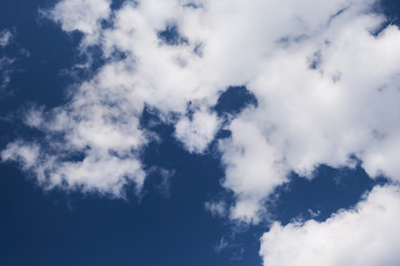 A fragment of a dark blue sky with clouds.