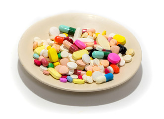 Different drug and pill on the plate isolated on white background for polypharmacy or multiple medication in elderly concept. Rational drug use concept. Copy sapce is also provided.