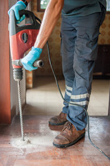 Technicians are using electric drill to penetrate the wood to compress chemical termite.Parquet...