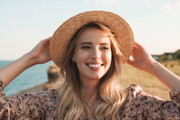 Photo of joyful attractive woman looking aside and smiling