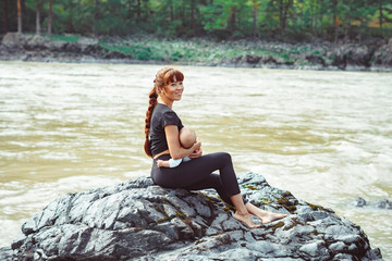 mother breastfeeding baby in nature