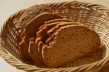 slices of emmer wheat bread in breakfast basket, chrunchy and healthy grain hulled wheat loaf