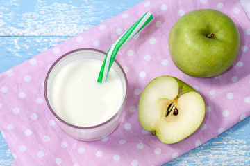 Ayran, homemade yogurt drink, kefir, lassi with green apples - healthy summer refreshing cold drink on a pink background. The concept of weight loss and healthy eating.