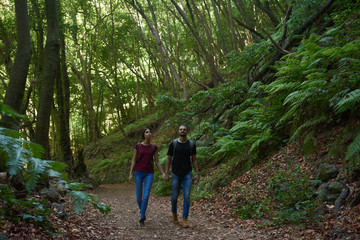 Naklejka na ściany i meble Couple talking a romantic walk in the woods