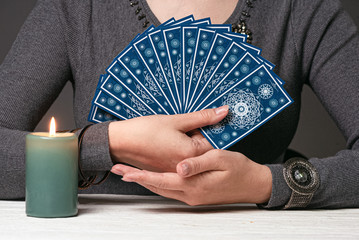 Deck of tarot cards in a fortune teller hands concept.