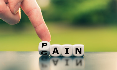 No pain no gain. Hand turns a dice and changes the word "pain" to "gain".