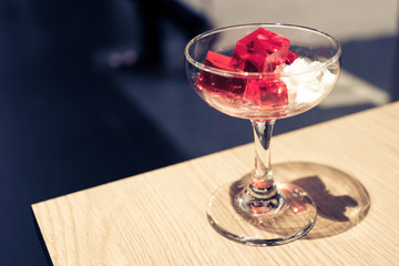 Red jelly with whipped cream in the restaurant.