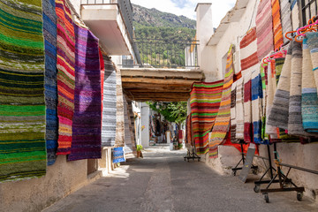 Colorful market street in a mediterranean village, Pampaneira.