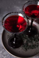 Two glasses with red cocktail for Halloween party on the dark background
