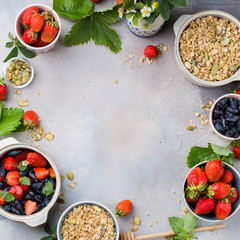 Granola with nuts and pumpkin seeds, a bonded berry on a gray concrete background - an ideal healthy breakfast