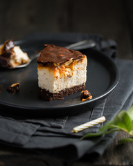 A classic creamy cheesecake with a chocolate base, roasted peanuts, salted caramel and chocolate - a favorite popular chocolate sweet