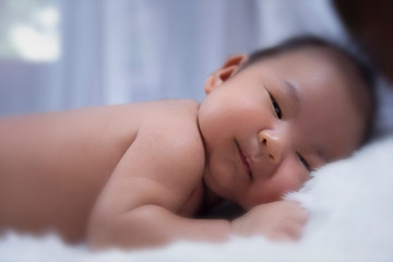 The blurry light design background of newborn baby,little smile,good emotion