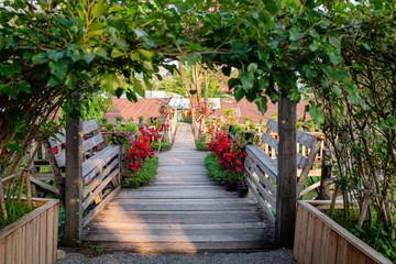 Wooden bridge with flowers on both sides