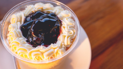 Blueberry cake dessert in a clear glass, paired with coffee