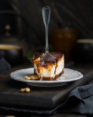 A classic creamy cheesecake with a chocolate base, roasted peanuts, salted caramel and chocolate - a favorite popular chocolate sweet