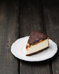 A classic creamy cheesecake with a chocolate base, roasted peanuts, salted caramel and chocolate - a favorite popular chocolate sweet
