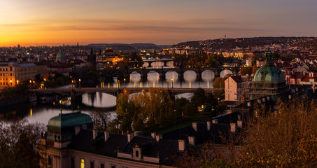 Fototapeta na wymiar Panorama, dawn over the city of Prague, Czech Republic, aerial view on Manes Bridges, Charles Bridge and Legion Bridge. Morning mood concept.