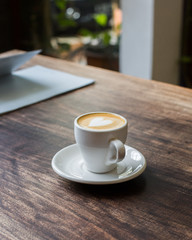 Freshly brewed coffee on a wooden table. Coffee Art - Milk Heart
