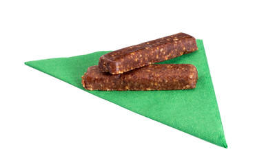 Raw pressed date and fruit bars with serviette isolated on white background. Healthy, gluten free...