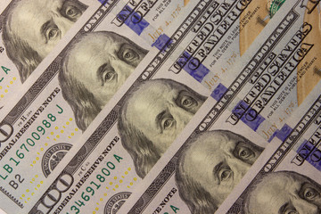 one hundred dollar bills lie on the table. Closeup photo