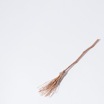 Halloween witch's broomstick. Minimal holiday celebration horror concept. Bright autumn season background.