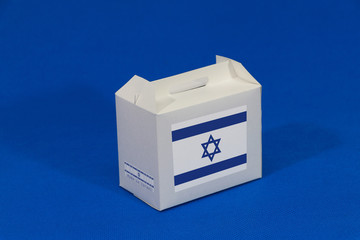 Israel flag on white box with barcode and the color of nation flag on blue background. The concept of export trading from Israel.