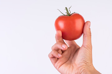 red tomato in hand