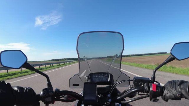 Motorcyclist riding on the Highway. View from behind the wheel of a motorcycle. POV