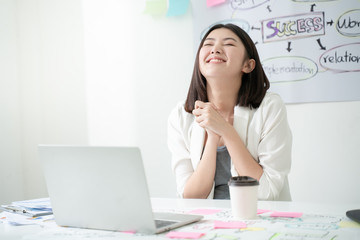 Asian young pretty business woman with notebook in the office.Beautiful Asian girl celebrate with laptop, success happy pose.Modern office or white room with copy space.